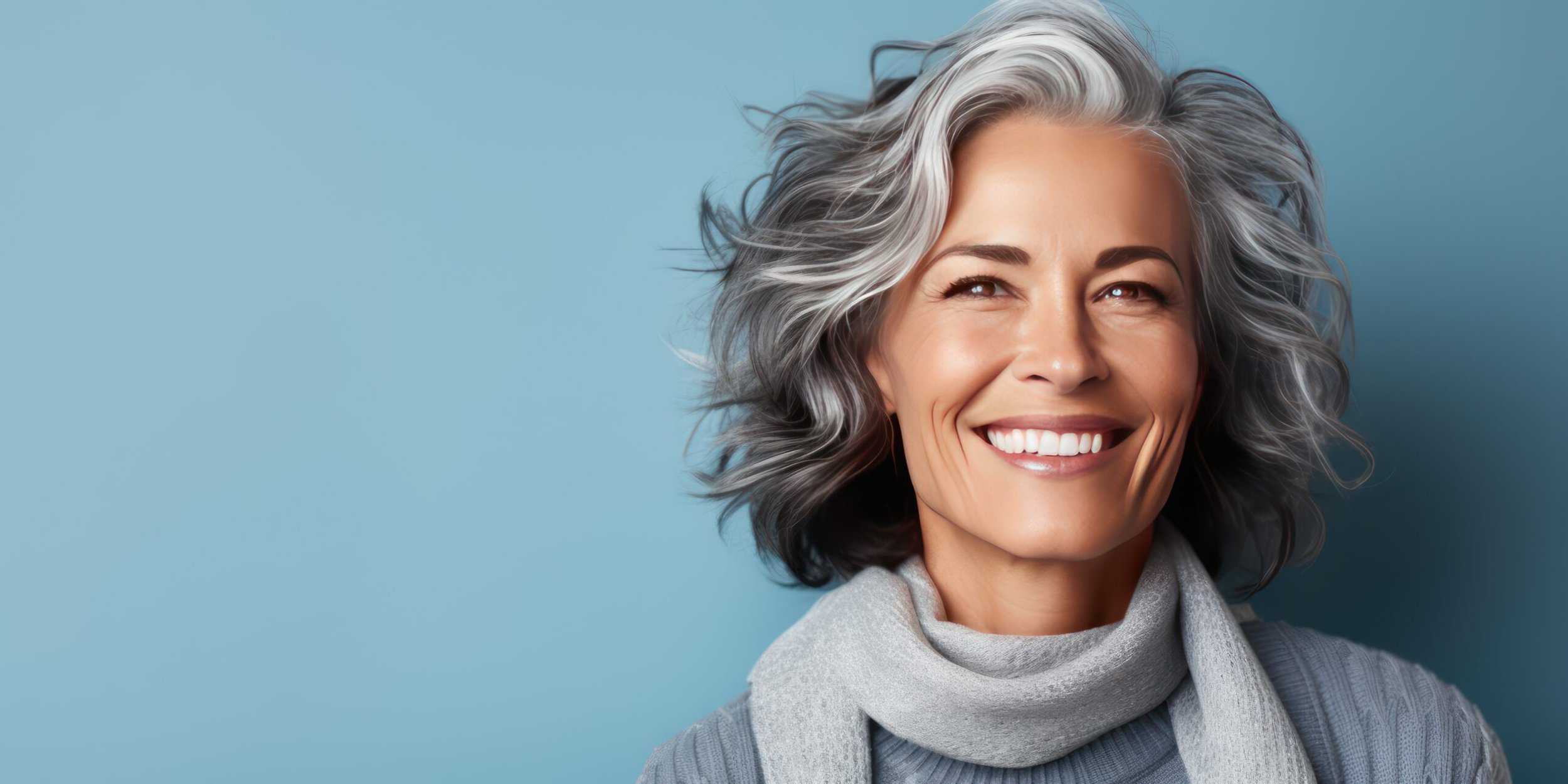 Smiling woman with a wavy silver-gray bob hairstyle